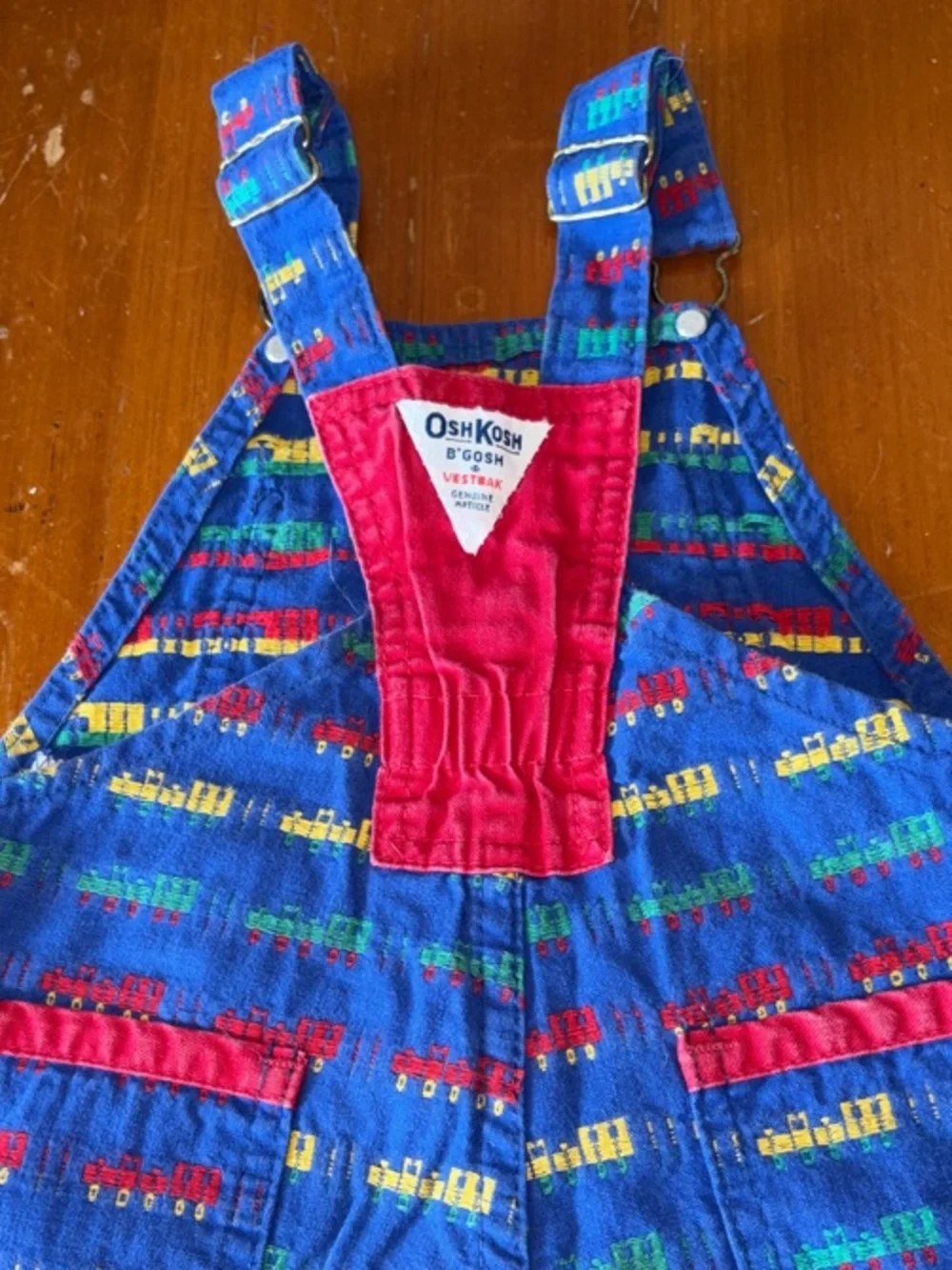 OshKosh B'gosh Bright Blue Overalls with Red, Yellow and Green Train Print